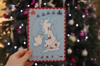 An image of the GCHQ Christmas Challenge Card in front of a Christmas tree