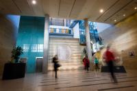 An image of GCHQ's Benhall atrium. Out of focus people walk past the camera.